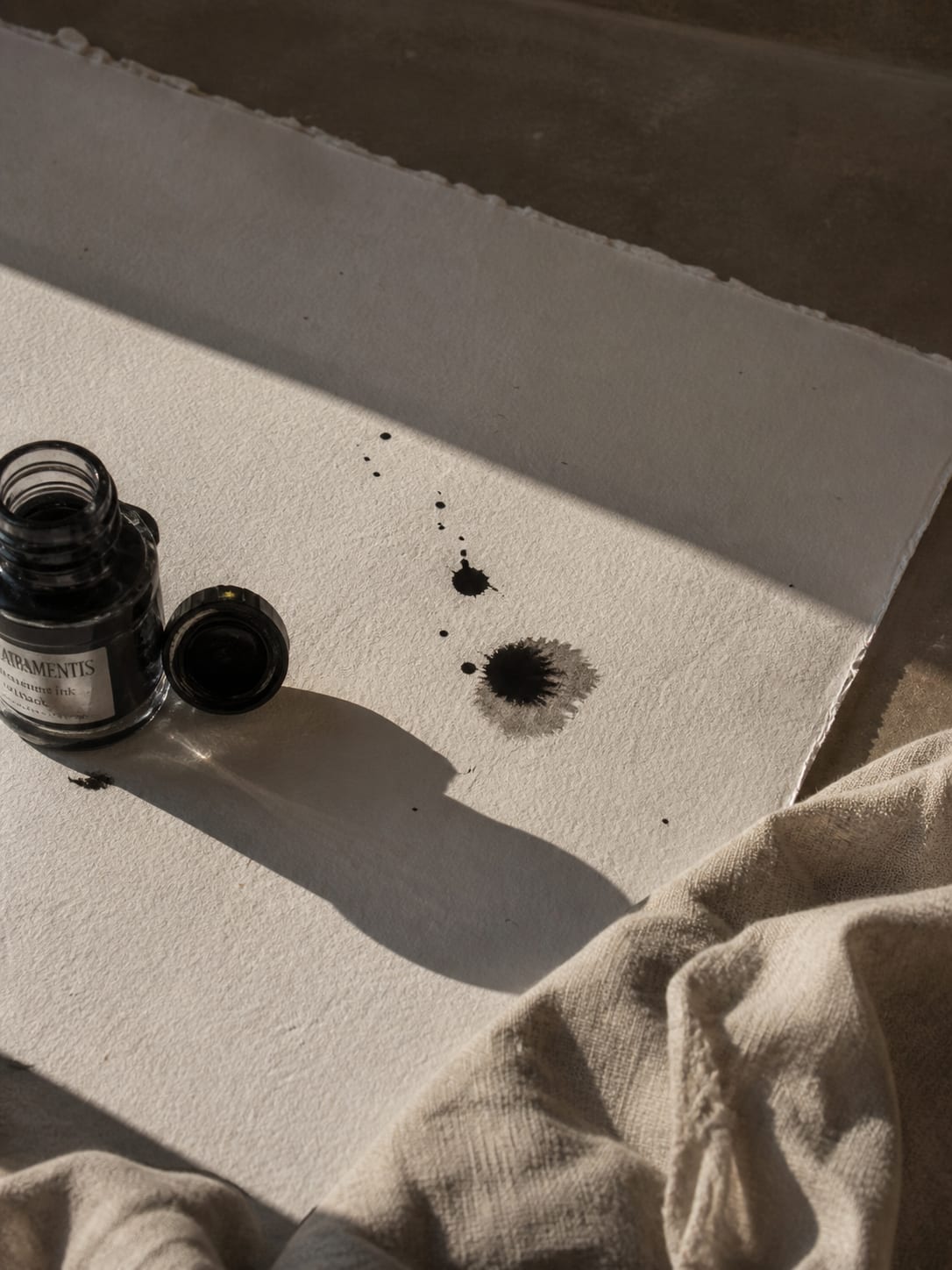 Black ink, splattered onto fibrous bone paper.