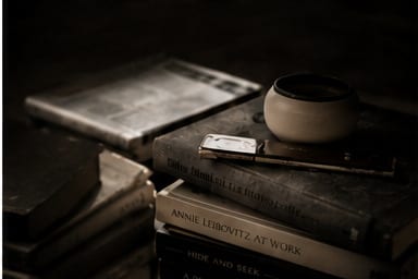 Stacked books and a coffee cup.